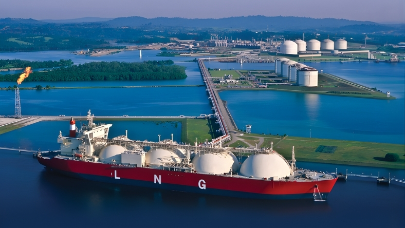 LNG carrier docked near liquefaction and storage facilities